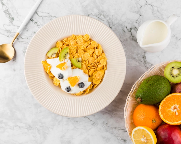 Flat lay cornflakes with yougurt and fruits