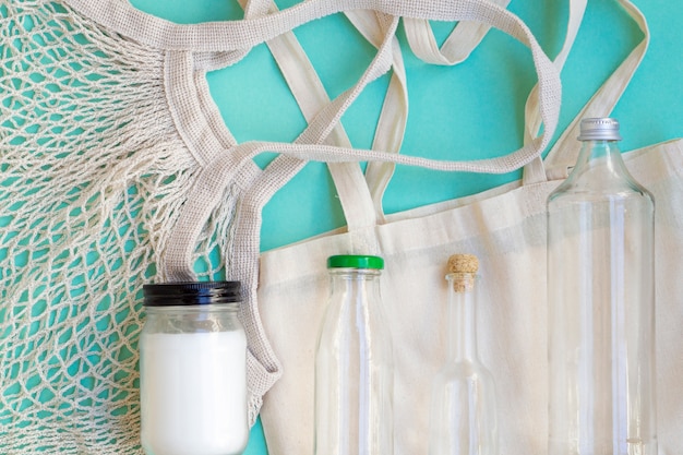 Flat lay cotton bag and bottles arrangement 