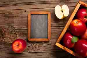 Free photo flat-lay crate with ripe apples with blackboard