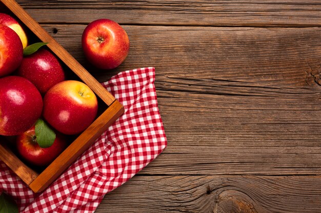 Flat-lay crate with ripe apples with copyspace