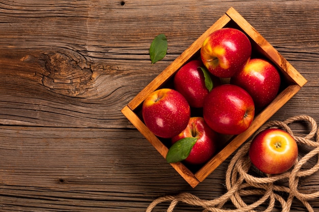 Flat-lay crate with ripe apples with copyspace