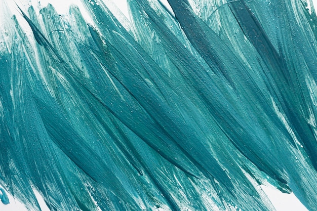 Flat lay of creative blue paint brush strokes on surface