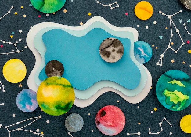 Free photo flat lay creative paper planets assortment