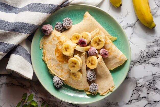 Flat lay crepes with mix of fruits