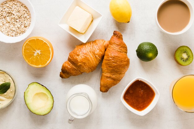 Flat lay croissants with butter and jam