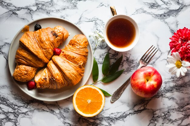 Flat lay croissants with fruits