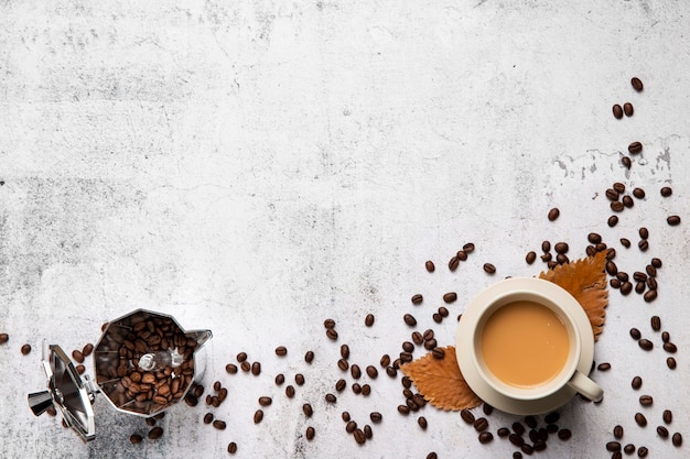 Flat lay cup of coffee and beans with copy space