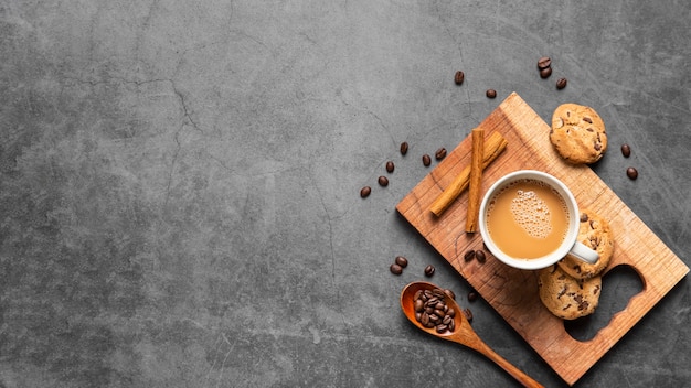 Free photo flat lay cup of coffee and cookies with copy space