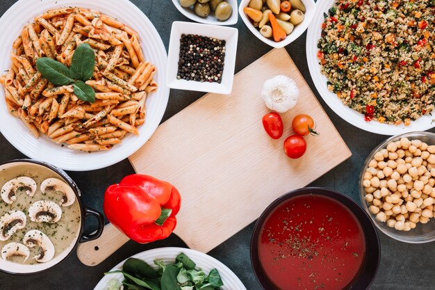 Flat lay of cutting board with garlic and cherry tomatoes