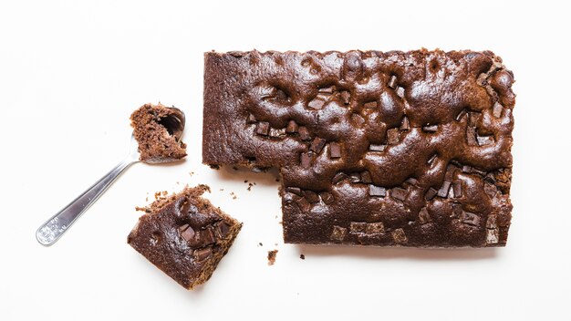 Flat lay dark chocolate cake with a spoon