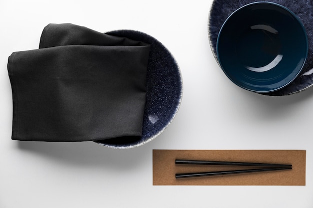 Flat lay of dark dinnerware with chopsticks