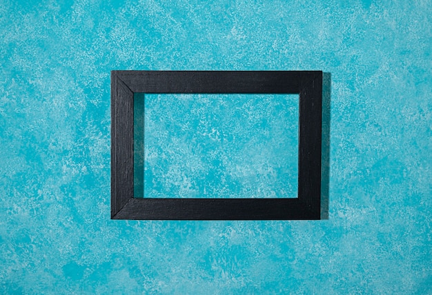 Flat lay dark frame on blue background