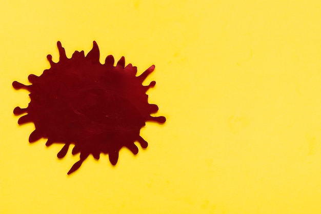 Free photo flat lay dark stains on yellow background