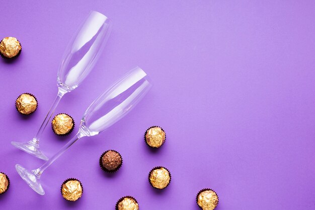 Flat lay decoration with chocolate balls and glasses