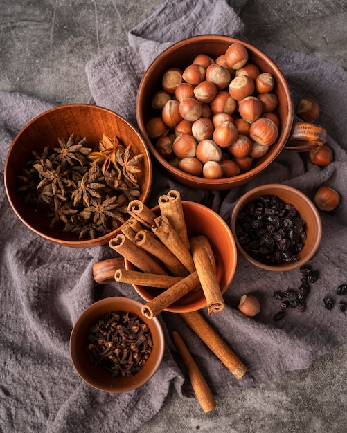 Flat lay decoration with cinnamon sticks and hazelnuts