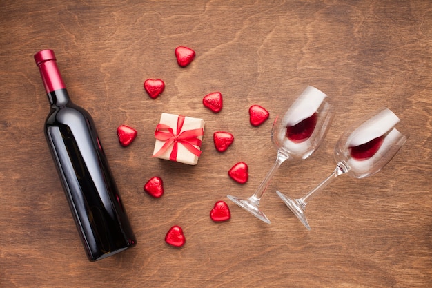 Flat lay decoration with heart shaped candies and wine