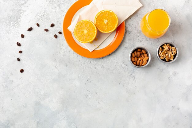 Flat lay decoration with juice and nuts in bowls