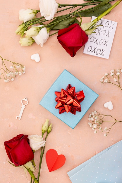 Flat lay decoration with present box and roses