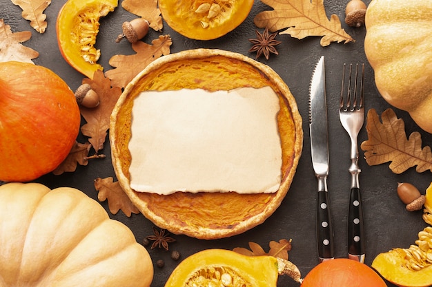 Flat lay decoration with pumpkins and pie