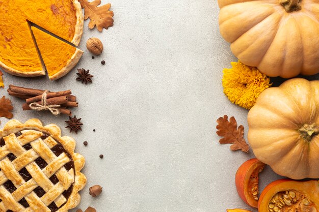 Flat lay decoration with pumpkins on stucco background