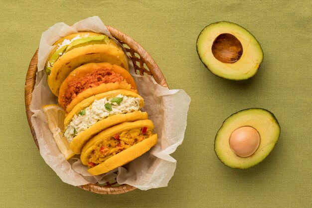 Flat lay delicious arepas and avocado