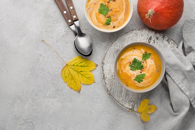 Flat lay delicious autumn soup composition on white background