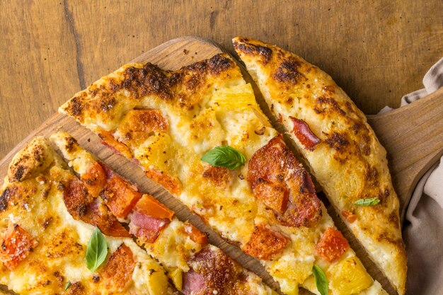 Flat lay of delicious baked pineapple and papaya pizza