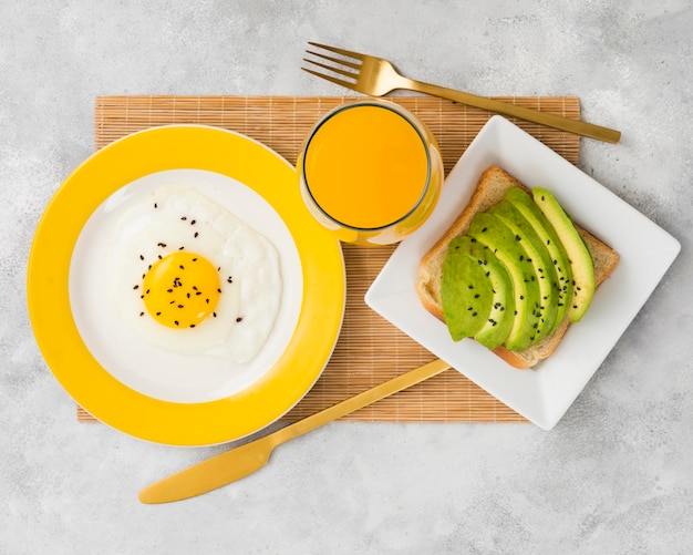 Flat lay of delicious breakfast with avocado