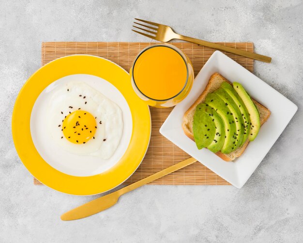 Flat lay of delicious breakfast with avocado