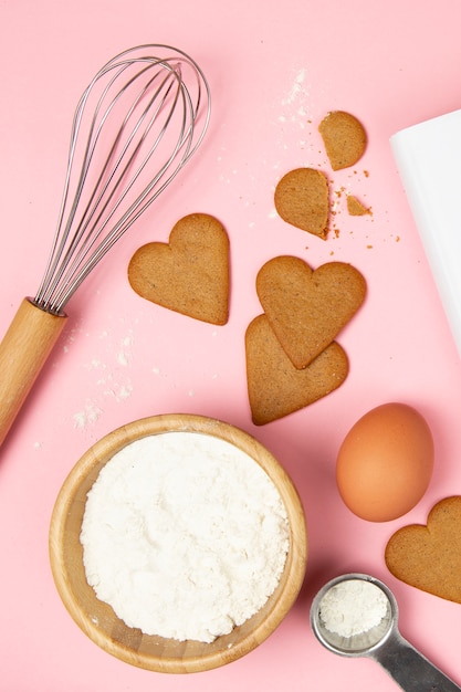 Flat lay of delicious cookies on pink background