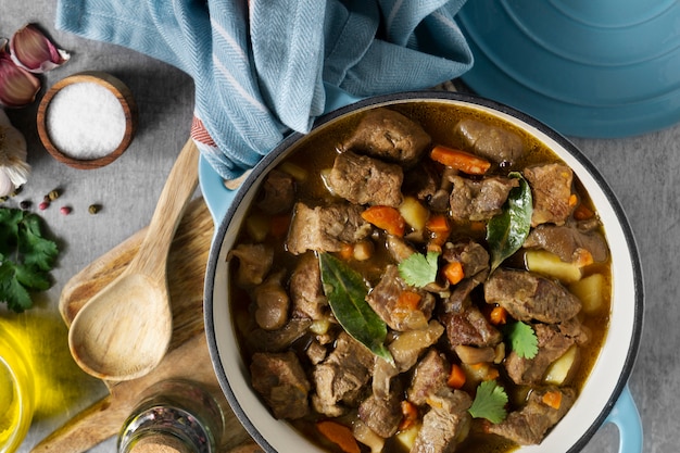 Flat lay delicious goulash and olive oil