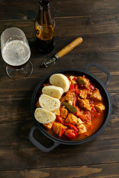 Flat lay delicious goulash on wooden table