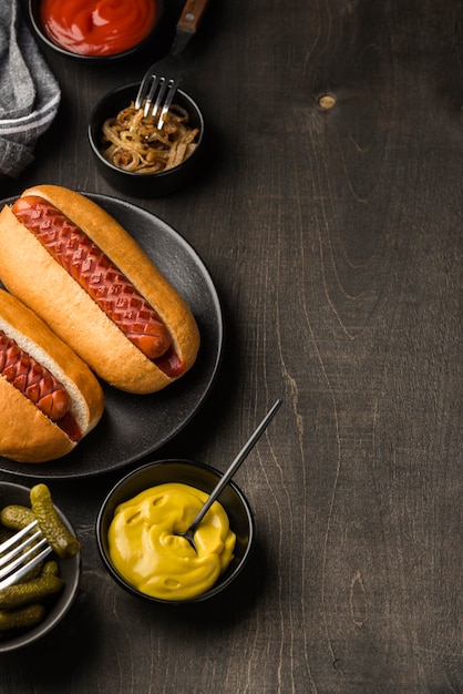 Flat lay delicious hot dogs on plate