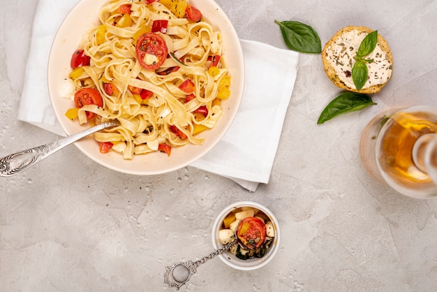 Flat lay of delicious italian food on plain background