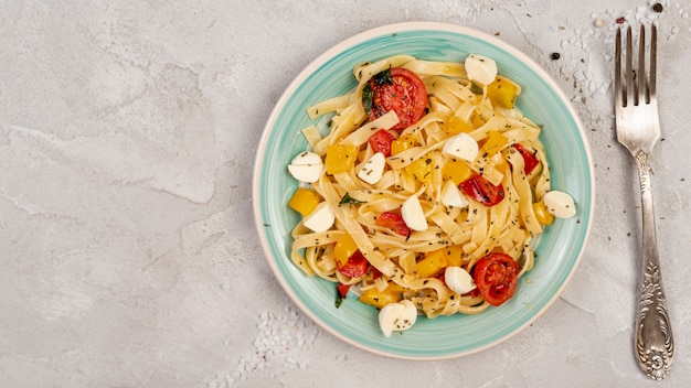 Flat lay of delicious italian pasta on plain background