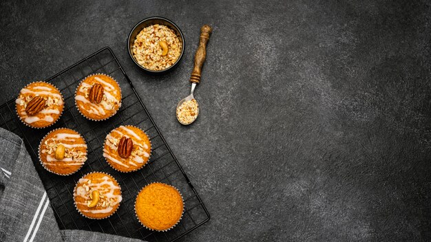 Flat lay of delicious muffins with nuts and copy space