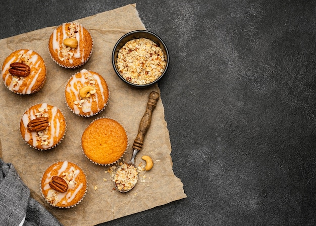 Flat lay of delicious muffins with nuts and copy space