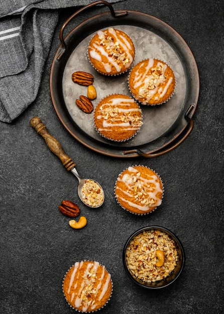 Flat lay of delicious muffins with nuts