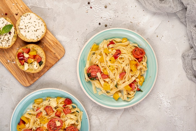 Flat lay of delicious pasta on plain background