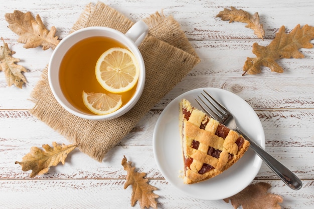 Flat lay delicious pie slice and tea cup
