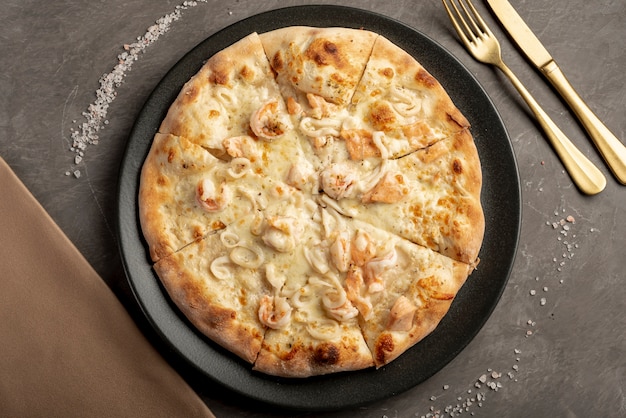 Flat lay of delicious pizza on table