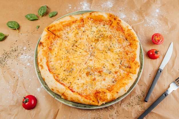 Flat lay of delicious pizza with fork and knife