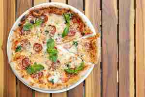 Free photo flat lay of delicious pizza on wooden table