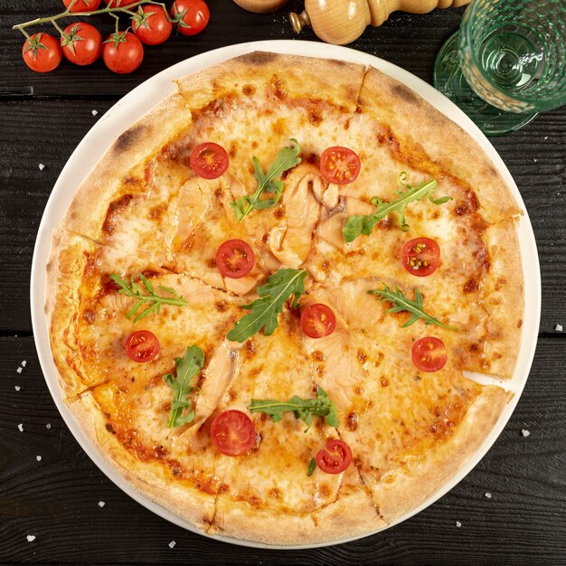 Flat lay of delicious pizza on wooden table