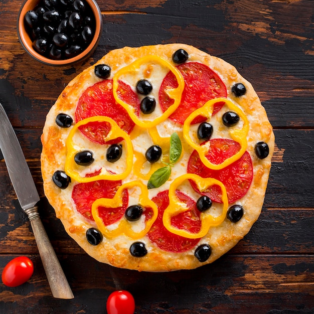 Flat lay of delicious pizza on wooden table