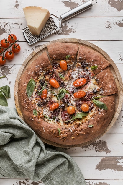 Flat lay of delicious sliced pizza with parmesan