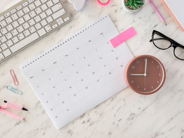 Flat lay desk calendar and clock