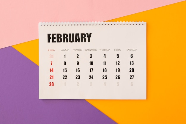 Flat lay desk calendar on colourful background