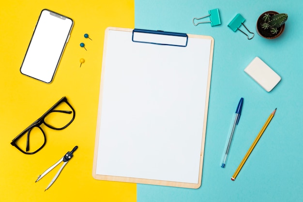 Flat lay desk concept with blank clipboard