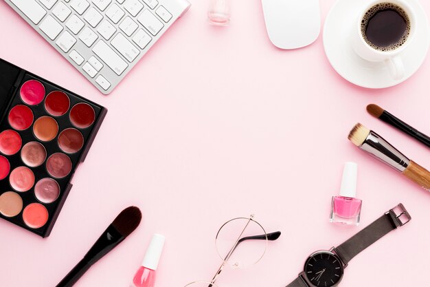 Flat lay desk items on pink background